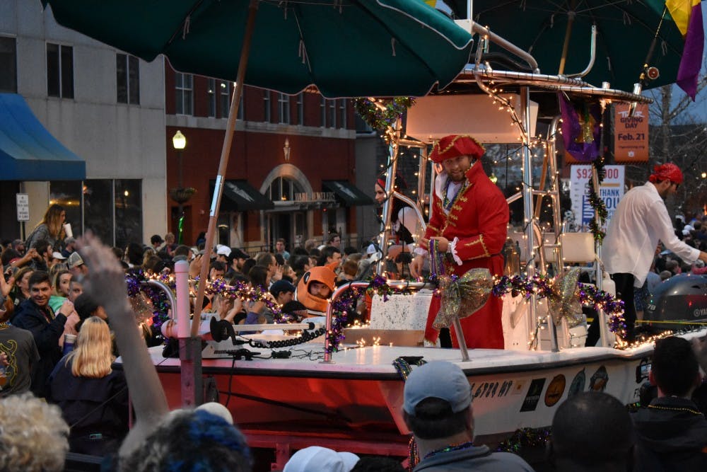 A Mardi Gras float rides through downtown on Feb. 10, 2018, in Auburn, Ala.