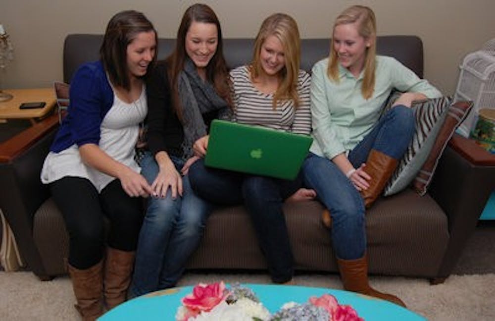 Mollie Lewis, Taylor Genau, Emily Philpot and Emily Peterman have fun watching funny YouTube videos about cats in their dorm in The Village. ( Rebekah Weaver / ASSISTANT PHOTO EDITOR)