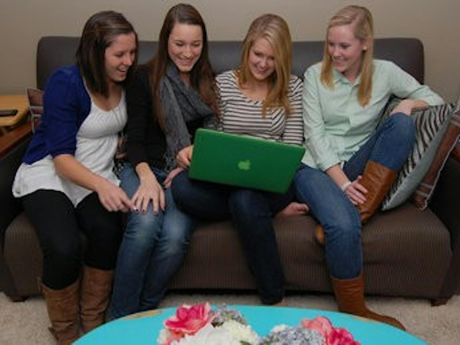 Mollie Lewis, Taylor Genau, Emily Philpot and Emily Peterman have fun watching funny YouTube videos about cats in their dorm in The Village. ( Rebekah Weaver / ASSISTANT PHOTO EDITOR)