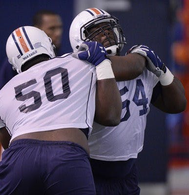 Defensive tackle Ben Bradley (left) blocks fellow lineman Jeffrey Whitaker on Auburn's first day of spring camp.