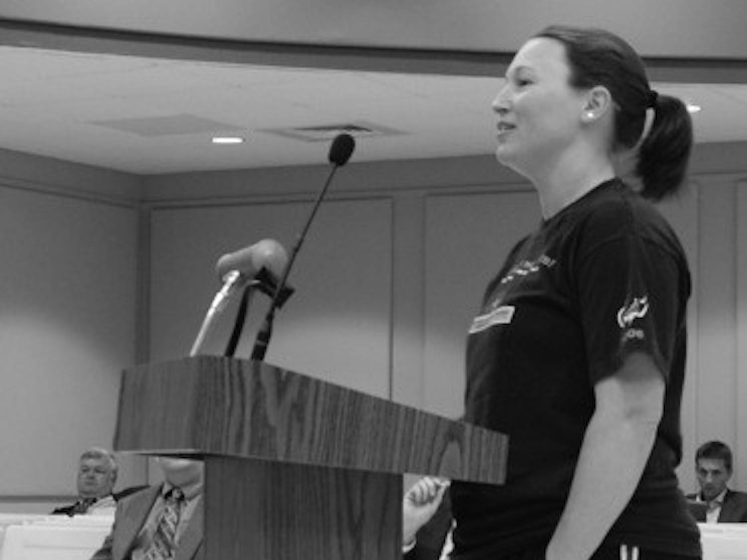 Jennifer Foster, right, attended the Auburn City Council meeting to show her concern about the possibility that a bar could be built so close to a day care.