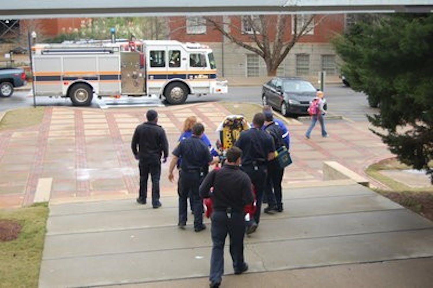 Firefighters and paramedics escort the unknown student out of the Haley Center. (Nathan Simone / MANAGING EDITOR)