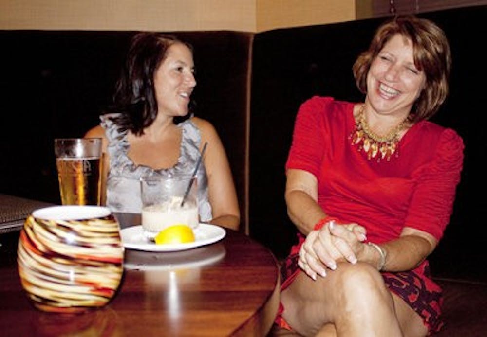 Jennifer Chambliss of Auburn and Patricia Contart of Florida enjoy an evening of jazz, drinks and laughter while celebrating Piccolo's one-year anniversary Saturday night. (Emily Adams / PHOTO EDITOR)