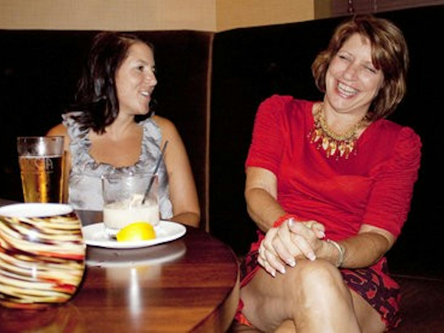 Jennifer Chambliss of Auburn and Patricia Contart of Florida enjoy an evening of jazz, drinks and laughter while celebrating Piccolo's one-year anniversary Saturday night. (Emily Adams / PHOTO EDITOR)