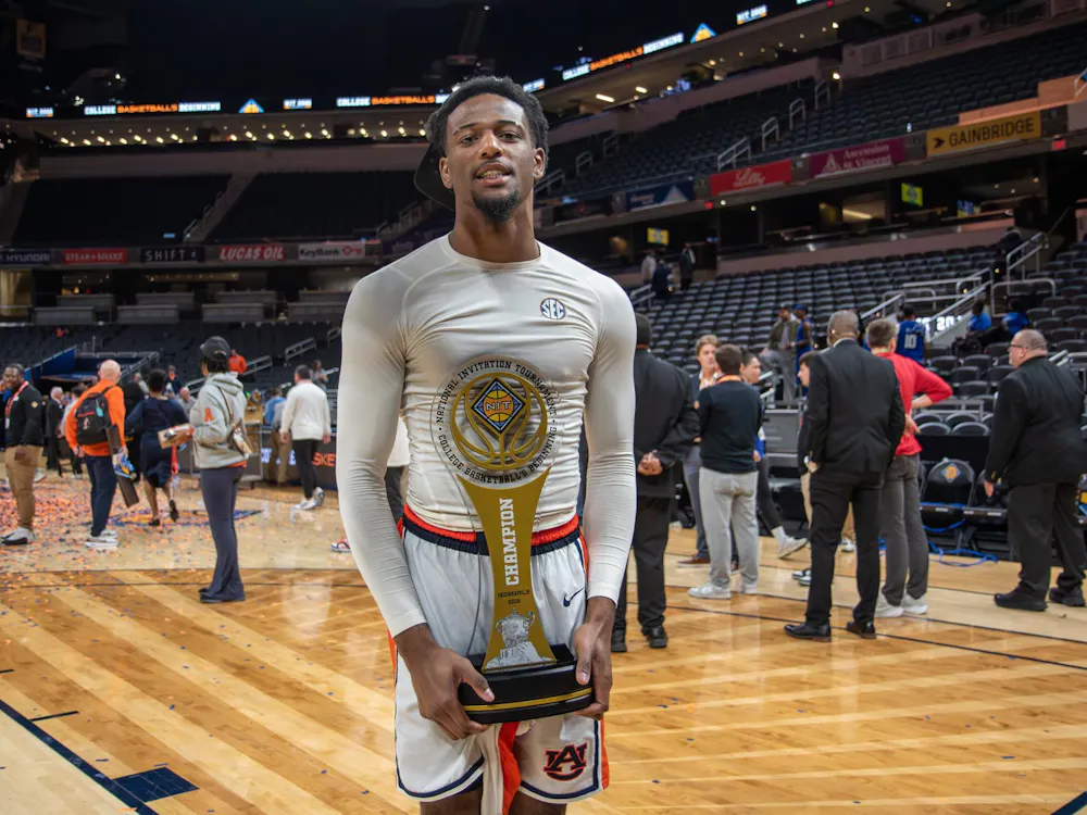 Kevin Overton holds trophy in celebration of winning the NIT championship game against Tulsa in Gainbridge Fieldhouse in Indianapolis, Ind on April 5, 2026.
