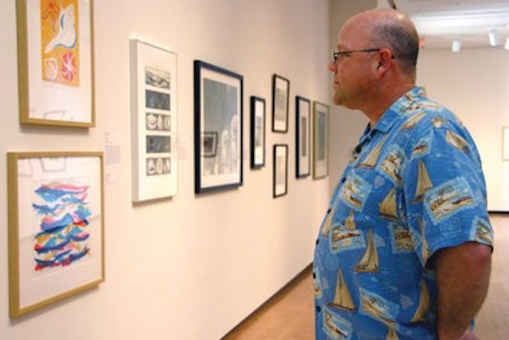 Visiting his son who attends Auburn, Richard Ramhold views a piece from the Edvard Munch exhibit Friday at the Jule Collins Smith Museum of Fine Art. Munch is famous for his paintings "The Scream" and "The Kiss." (Rebekah Weaver / Assistant Photo Editor)