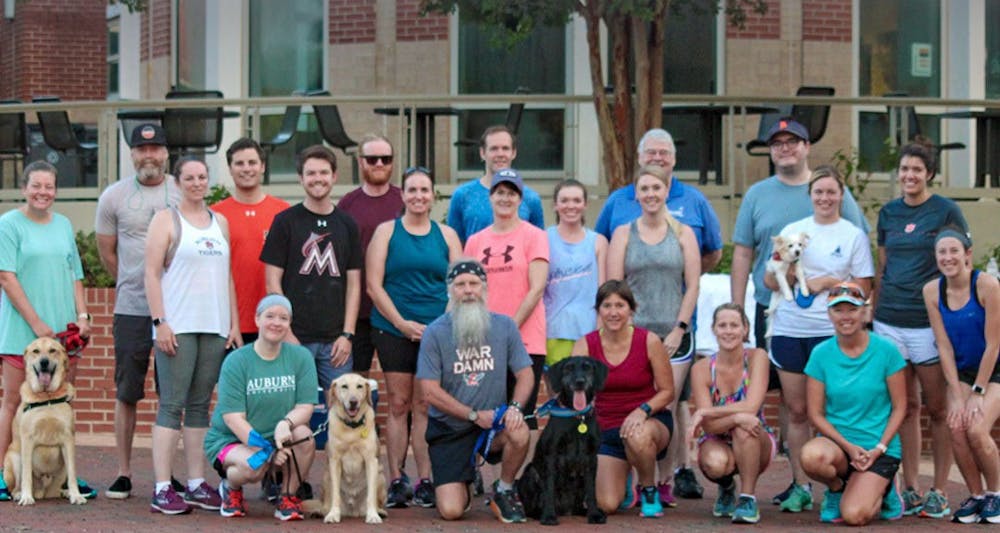 <p>Dr. Doug Hankes (bottom row, second from left) after a run with parents at a 2019 Camp War Eagle session.</p>