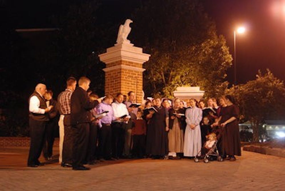 Sand Hill Church members sing hymns at Toomer's Corner.