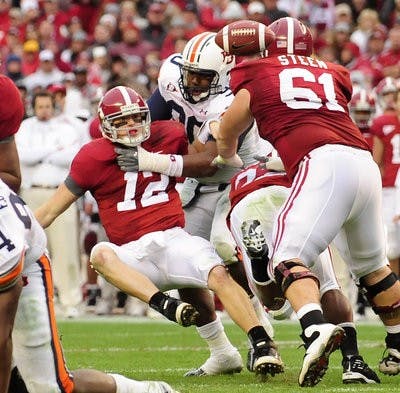 Auburn's Nick Fairley sack Alabama quarterback Greg McElroy causing a fumble late in the first half. (Todd Van Emst / Auburn Media Relations)