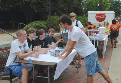Steven Trecu, sophomore in English, speaks with the Auburn Film Society at O-Days on the concourse. O-Days is an indispensable recruiting tool for campus organizations. (Elaine Busby / Assistant Photo Editor)