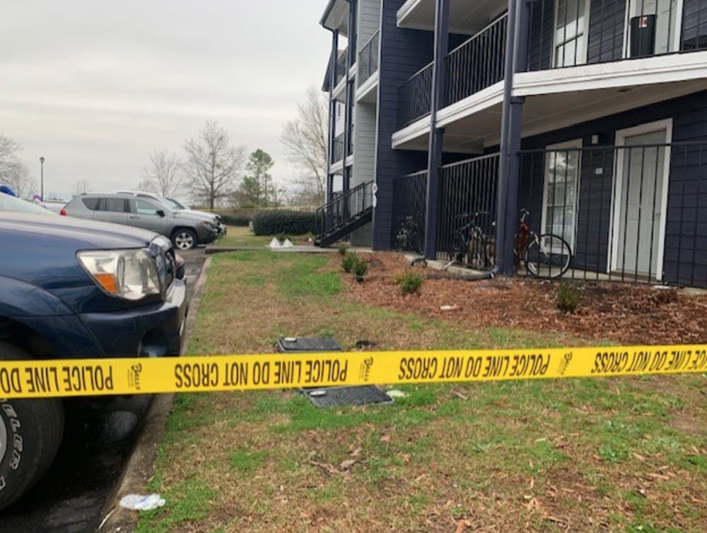 <p>Crime tape surrounds a building in the Evergreen apartment complex on Feb. 16, 2020.&nbsp;</p>