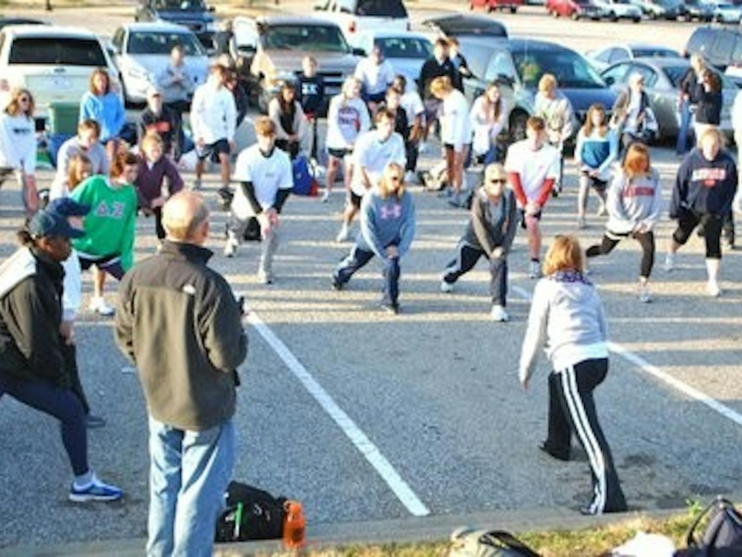Participants in the 2010 Hunger March, led by the Committee of 19, stretch to prepare for their first day of walking. (Contributed)