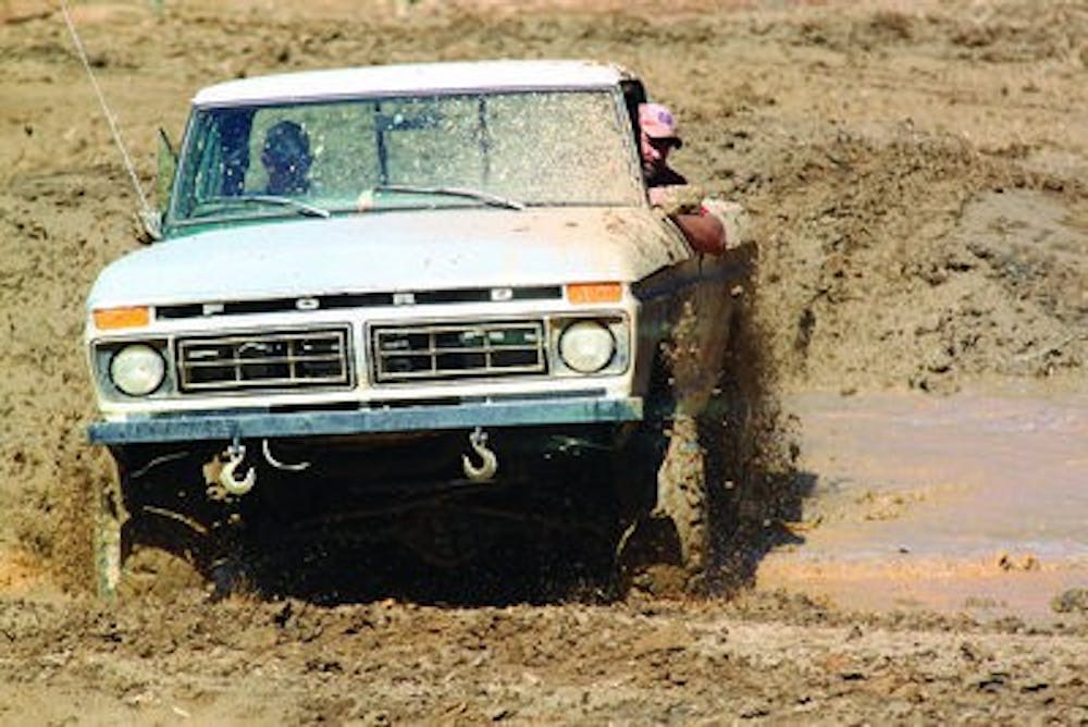 David Phillips drives his Ford truck through a field of mud Saturday morning at The Great American Park. The 165-acre park also offers areas for rock crawling and ATV riding. (Emily Adams / Photo Editor)