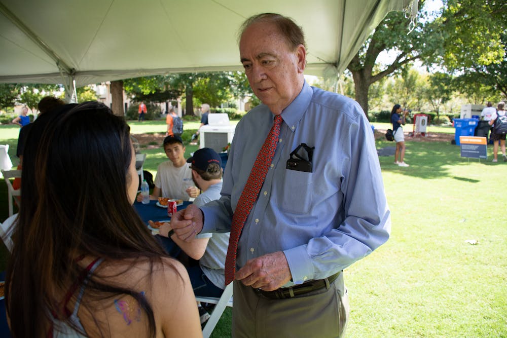 Auburn University President Jay Gogue meets with a student during Pizza and Popsicles with the President at the President's Home on Wednesday, Aug. 18, 2021, in Auburn, Ala.  