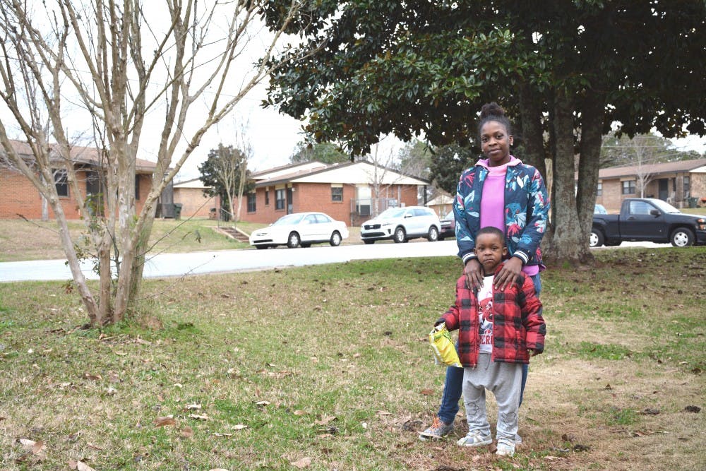 <p>&nbsp;</p>
<p>Gabrielle Johnson and her son, Bryson-Elijah, stand outside their home in Auburn, Alabama, on Jan. 22, 2019.</p>