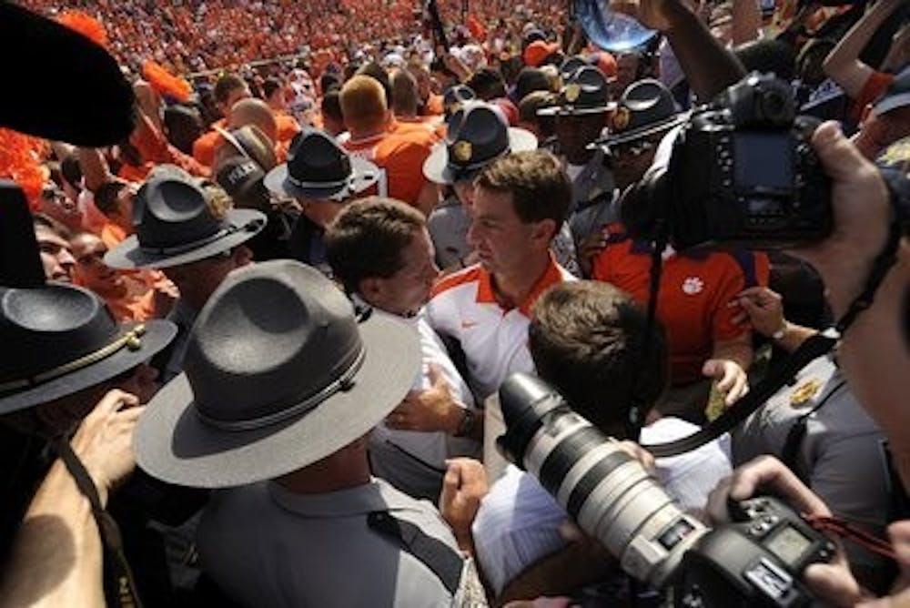 Gene Chizik and Clemson coach Dabo Sweeney shake hands after the game. (Todd Van Emst / ATHLETICS PHOTOGRAPHER)