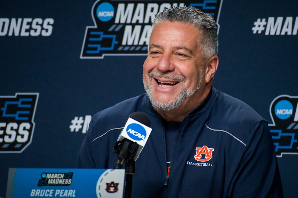 Auburn head coach Bruce Pearl shares a smile while answering questions from reporters about the team's upcoming NCAA Tournament second-round matchup against Miami during a press session in Greenville, South Carolina, on March 19, 2022.