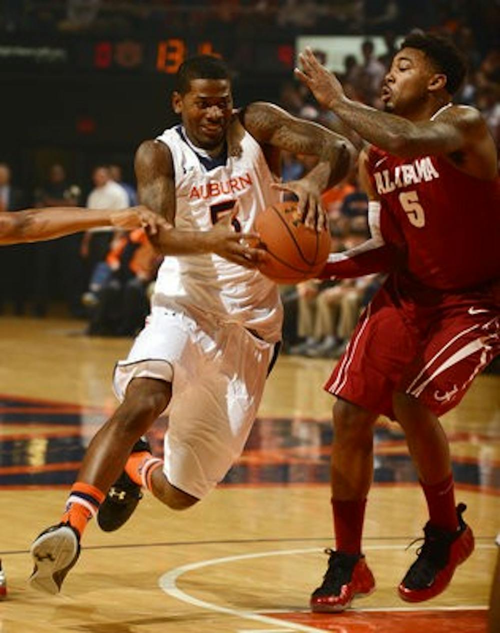 Shaquille Johnson drives around Alabama's Trevor Lacey in the first half. (Courtesy of Todd Van Emst / AUBURN ATHLETICS PHOTOGRAPHER)