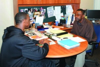 Troy Smith advises Antonio Goodwin, undeclared freshman and wide receiver for the football team. (Elaine Busby / Assistant Photo Editor)