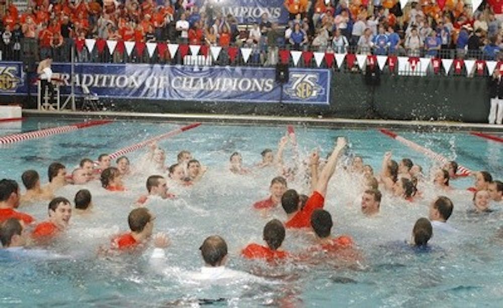 The Auburn mens and womens swimming and diving teams celebrate winning the SEC Swimming and Diving Championships. Auburn coach Richard Quick is center.Auburn SEC Swimming Finals on Saturday, Feb. 25, 2008 in Tuscaloosa, Ala.. Todd Van Emst