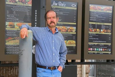 Owner of Jim Bob's, Chuck Ferrell, stands in front of the new drive-thru of the Tiger Town location. (Rebekah Weaver / Assistant Photo Editor)