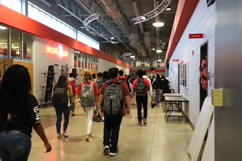 <p>Students walk the halls of Opelika High School on the first day of classes on Aug. 9, 2021, in Opelika, Ala.</p>