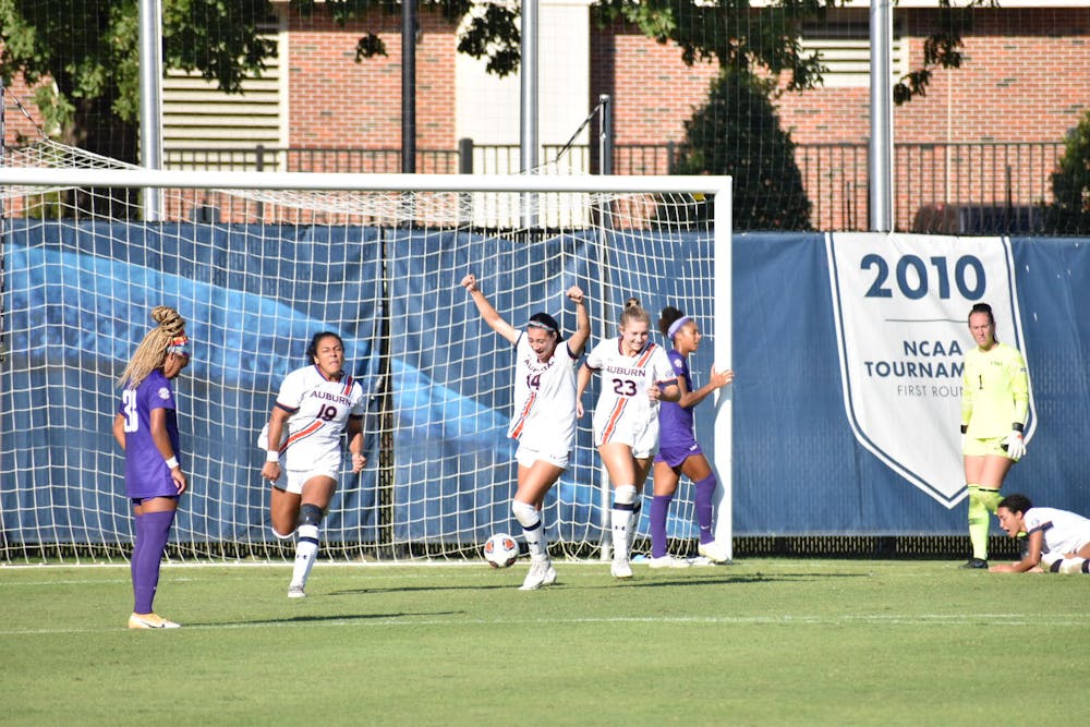 <p>Oct. 10, 2021; Auburn, AL, USA; Auburn celebrates as an LSU player looks on after scoring the game-winning goal in overtime in a match between Auburn and LSU at the Auburn Soccer Complex.</p>
