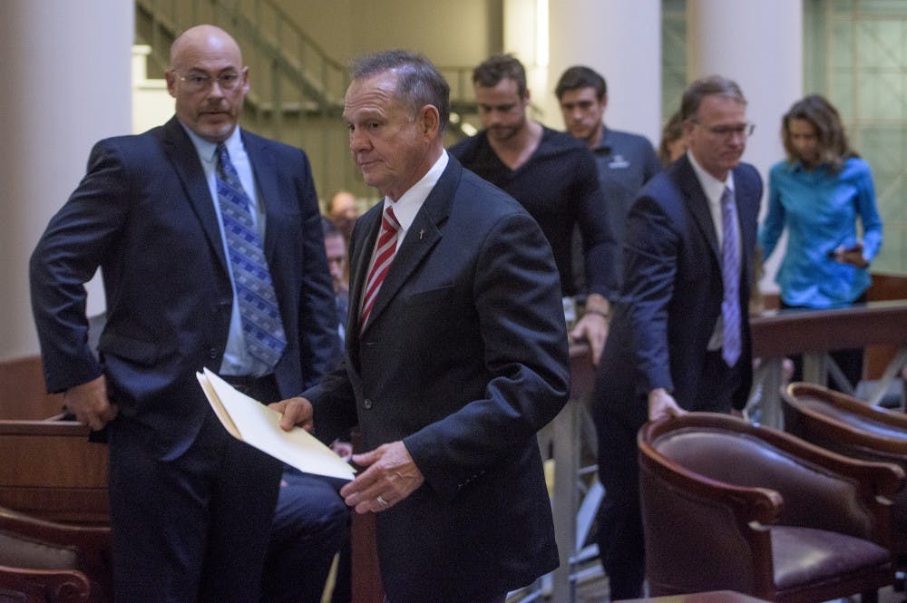 Roy Moore and his attorney and supporters walk out of the Supreme Court Chamber, in Montgomery, Ala., on Thursday October 27, 2016 before the lottery is held to pick the judges who will hear his appeal.