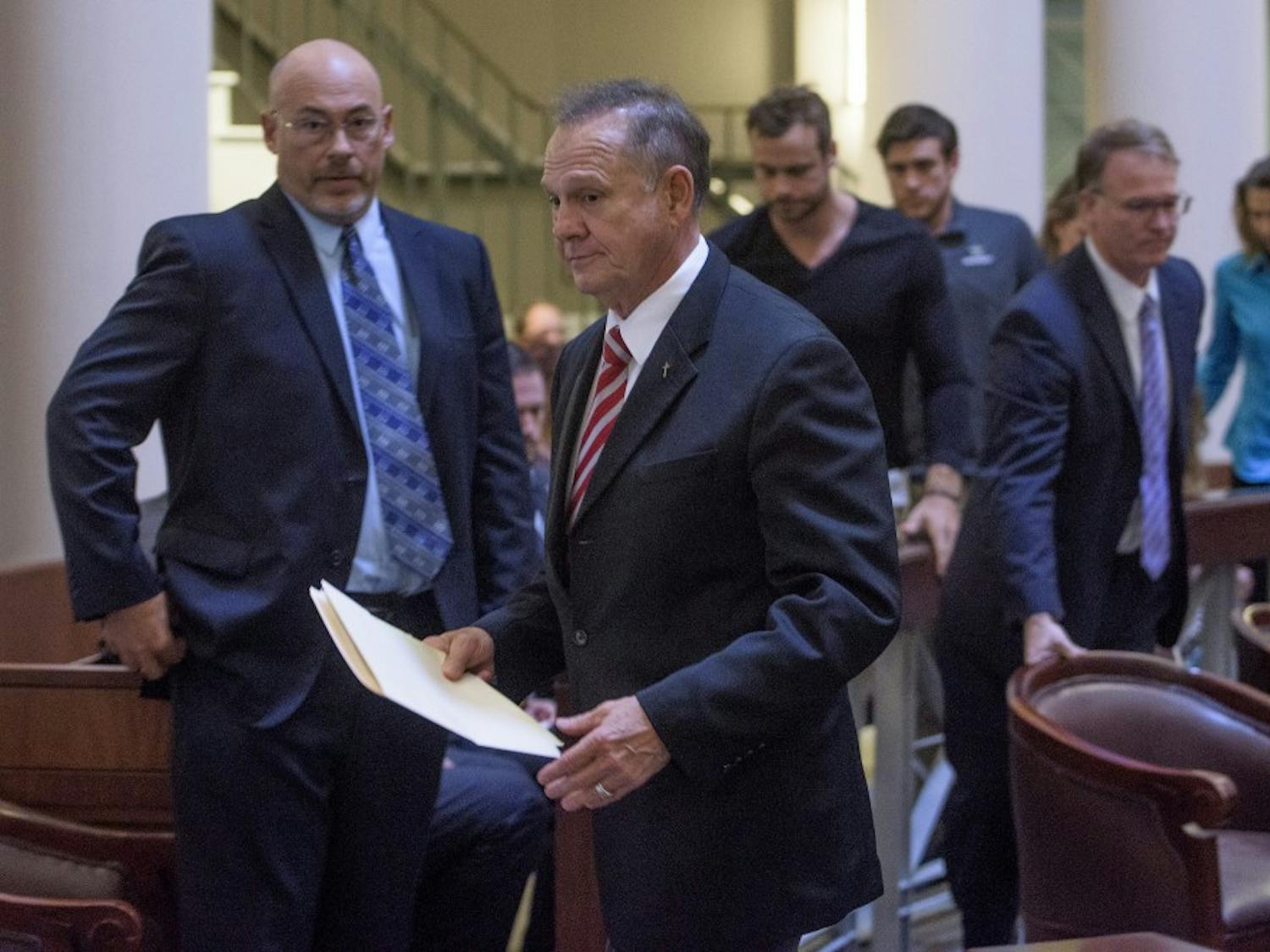 Roy Moore and his attorney and supporters walk out of the Supreme Court Chamber, in Montgomery, Ala., on Thursday October 27, 2016 before the lottery is held to pick the judges who will hear his appeal.