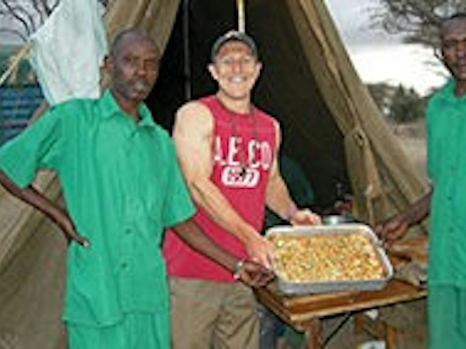 While in Kenya, Tyler Viars (right) worked with the locals and cooked meals with them.