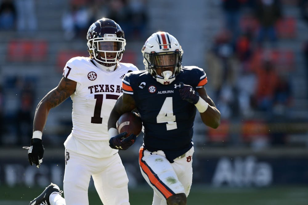 <p>Tank Bigsby (4) getting chased by a defender during the game between Auburn and Texas A&amp;M at Jordan Hare Stadium on Dec. 5, 2020; Auburn AL, USA. Photo via: Todd Van Emst/AU Athletics</p>