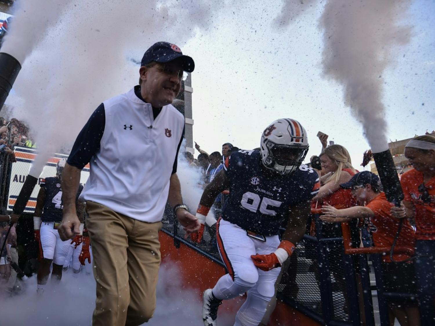 Gus Malzahn and Dontavius Russell (95) enter the field prior to a NCAA college football game, Saturday, Oct. 1, 2016, in Auburn, Ala.