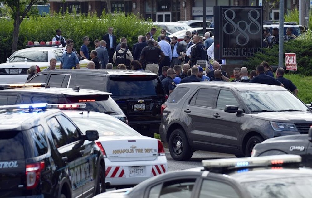 <p>Police secure the scene of a shooting in Annapolis, Md., Thursday, June  28, 2018. A single shooter killed several people Thursday and wounded  others at a newspaper in Annapolis, Maryland, and police said a suspect  was in custody.</p>