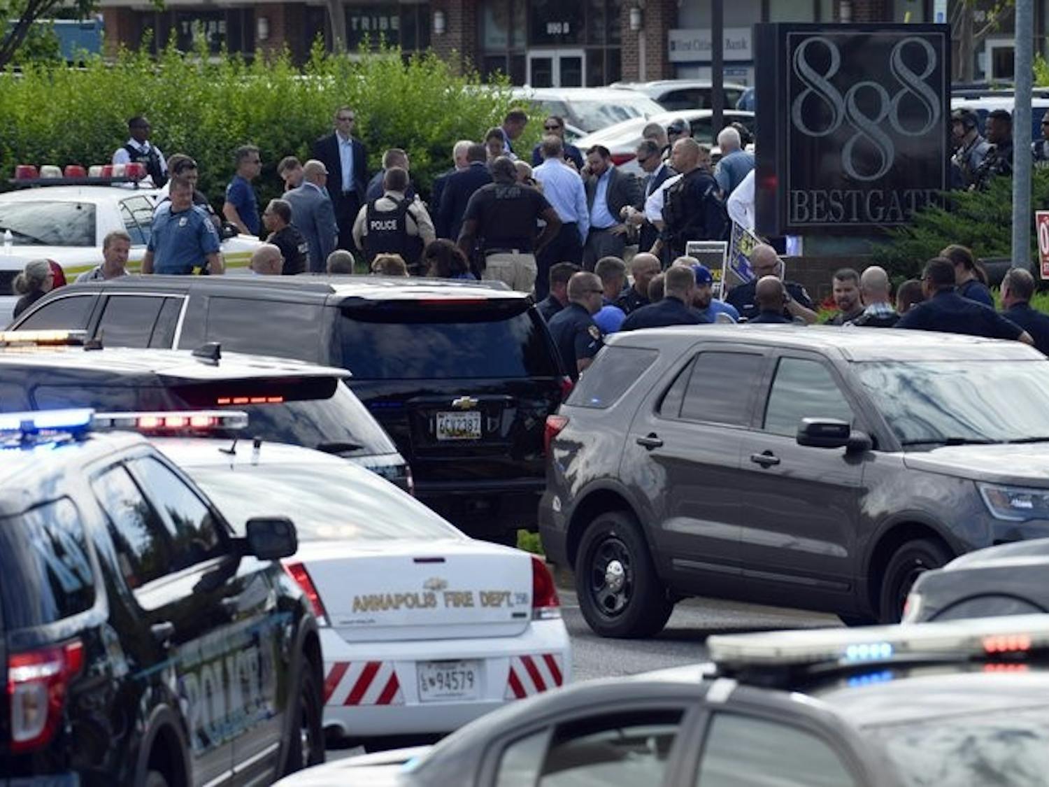 Police secure the scene of a shooting in Annapolis, Md., Thursday, June 28, 2018. A single shooter killed several people Thursday and wounded others at a newspaper in Annapolis, Maryland, and police said a suspect was in custody.