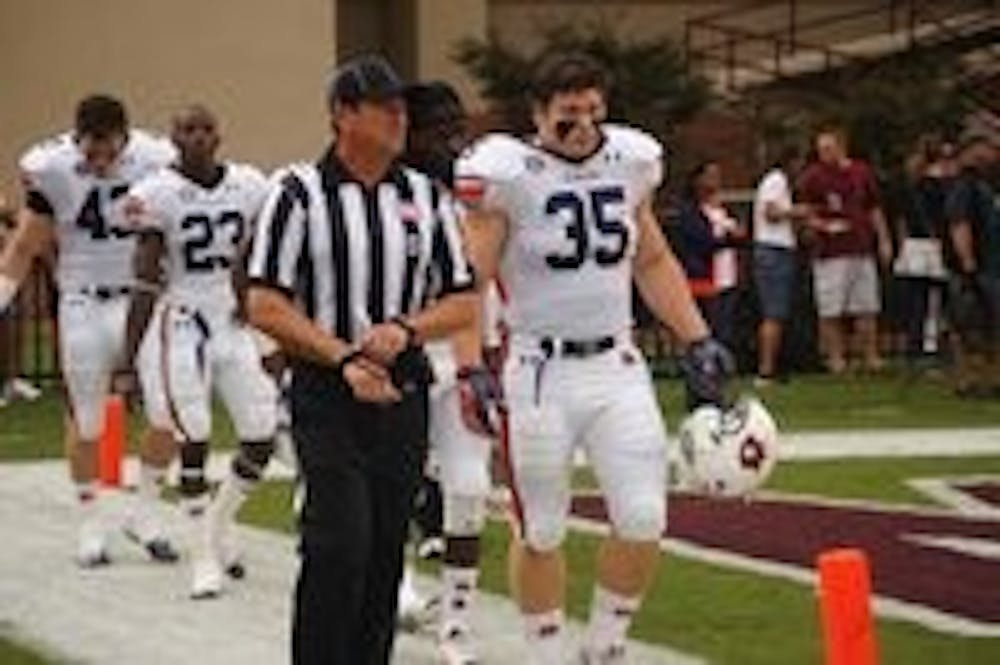 Fullback Jay Prosch leads the team captains on the field before the game. (Robert E. Lee / EDITOR-IN-CHIEF)