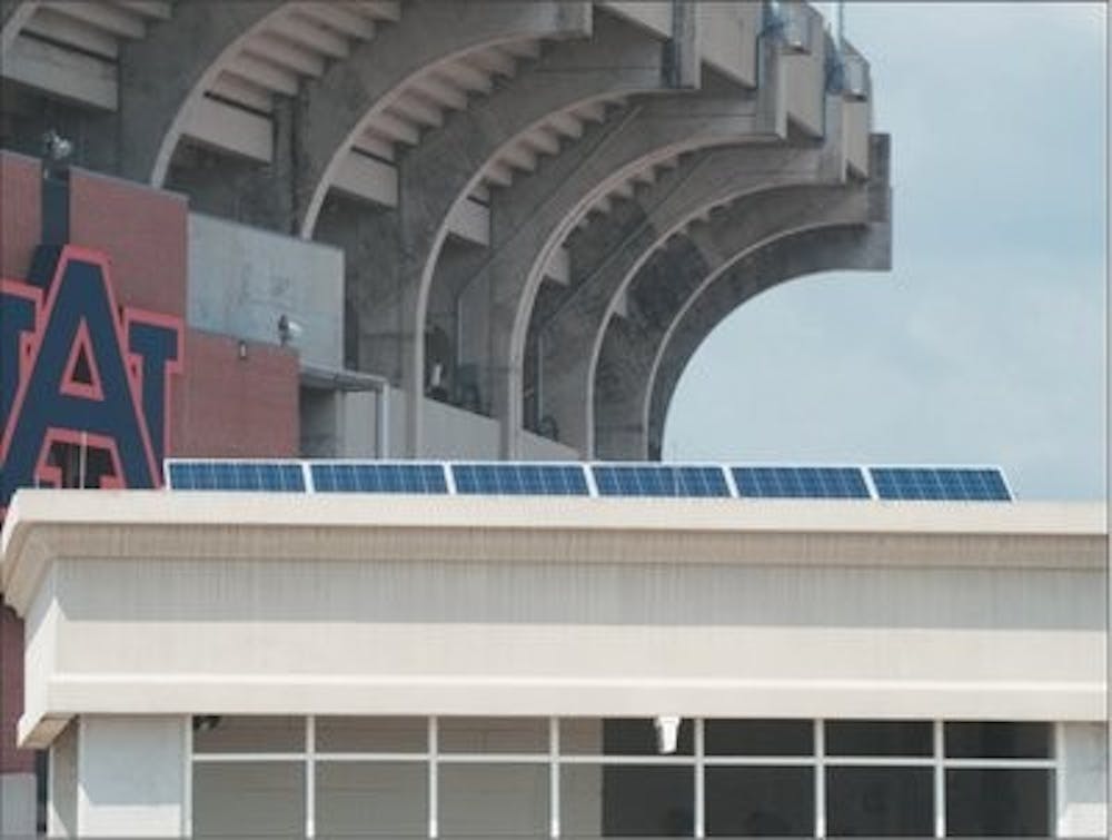 Solar panels on the roof of a University parking deck transmit power to electric vehicles below.