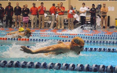 Sophomore Tony Cox flies across the pool in an attempt to beat rival swimmers from Louisiana State University Friday. (Elaine Busby  / Assistant photo editor)