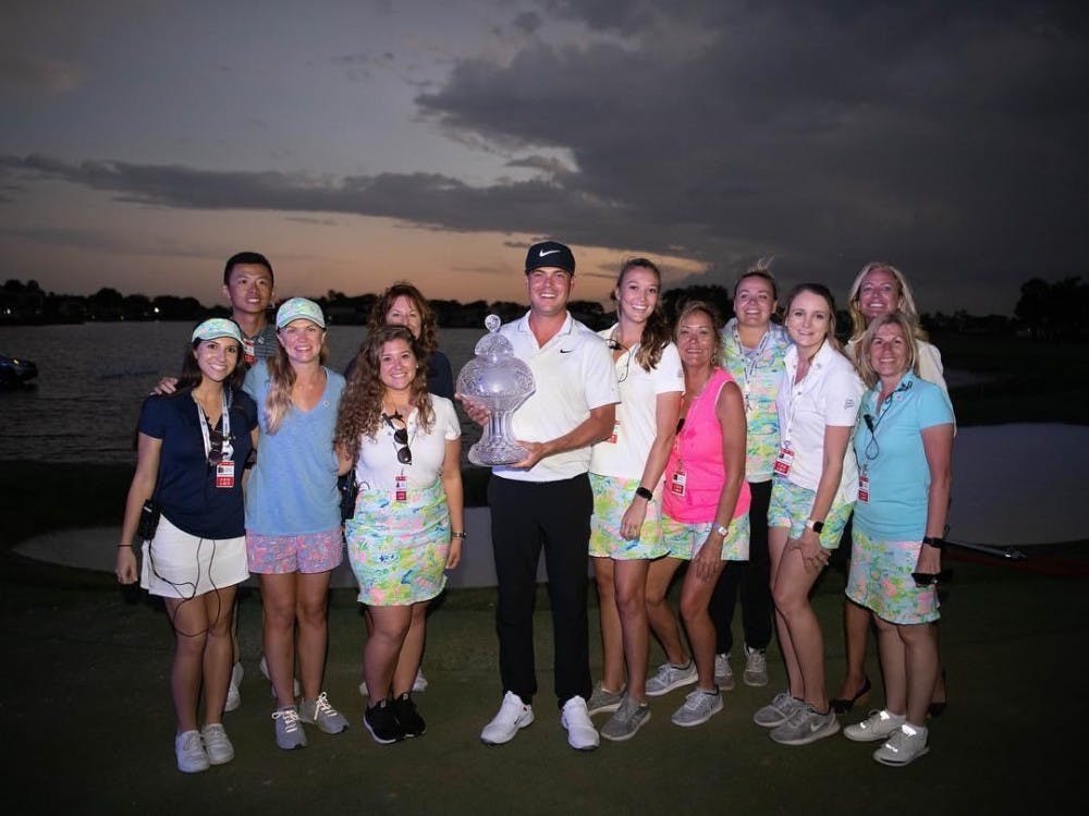 <p>Madison Temple poses for photo with the winner of the Honda Classic.&nbsp;</p>