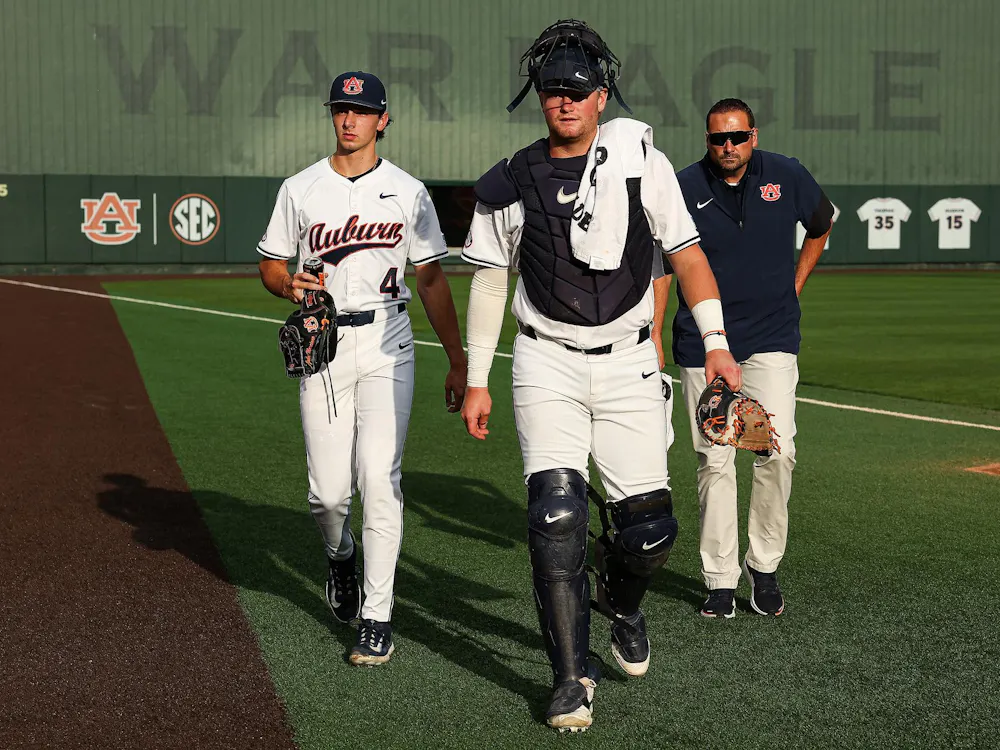 AUBURN, AL - APRIL 25 - Auburn's Chase Fralick (3), Auburn's Jake Marciano (4), Auburn Senior Assistant Athletic Trainer Anthony Sanderson - #6 Auburn Tigers vs. #9 Oklahoma Sooners at Plainsman Park in Auburn, AL on Saturday, April 25, 2026. Photo by Zach Bland/Auburn Tigers
