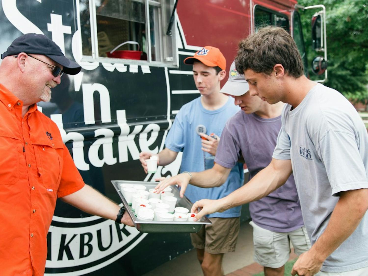 Students pick up mini milkshakes from the Steak 'n&nbsp;Shake food truck during the fall's first Family Friday on Aug. 17, 2018, in Auburn, Ala.