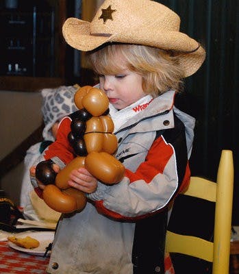 Cowboy Tyler Burt holds his horse-shaped balloon at Storybook Farm's "Cowboy Roundup" Feb. 5. The event benefits Storybook's ministry to children with special needs. (Rebekah Weaver / Assistant Photo Editor)