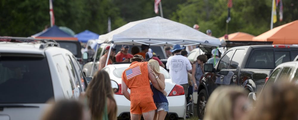 <p>Two Rodeo attendees dance to music at the event in the tailgate area. (Contributed by Zach Bland) </p>