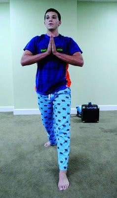 Barrett "Bear" Townsend teaches a yoga pose to the students in his class. (Maria Iampietro / PHOTO EDITOR)