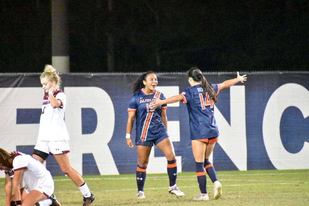 <p>Nov. 2, 2021: Marissa Arias (19) celebrates with Sydney Richards (14) during a match between South Carolina and Auburn during the second round of the SEC Soccer Tournament in Orange Beach, Ala.</p>