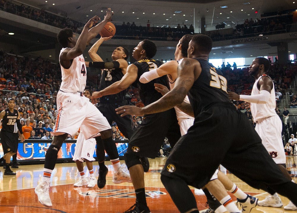 <p>Missouri guard Jordan Clarkson (5) shoots while being defended by Auburn center Matthew Atewe (41). (File photo)</p>
