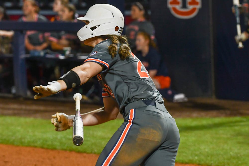 Auburn catcher Jessie Blaine (22) drops the bat and turns towards first base during a game against Merrimack on Jane B Moore Field on Feb. 25, 2023.