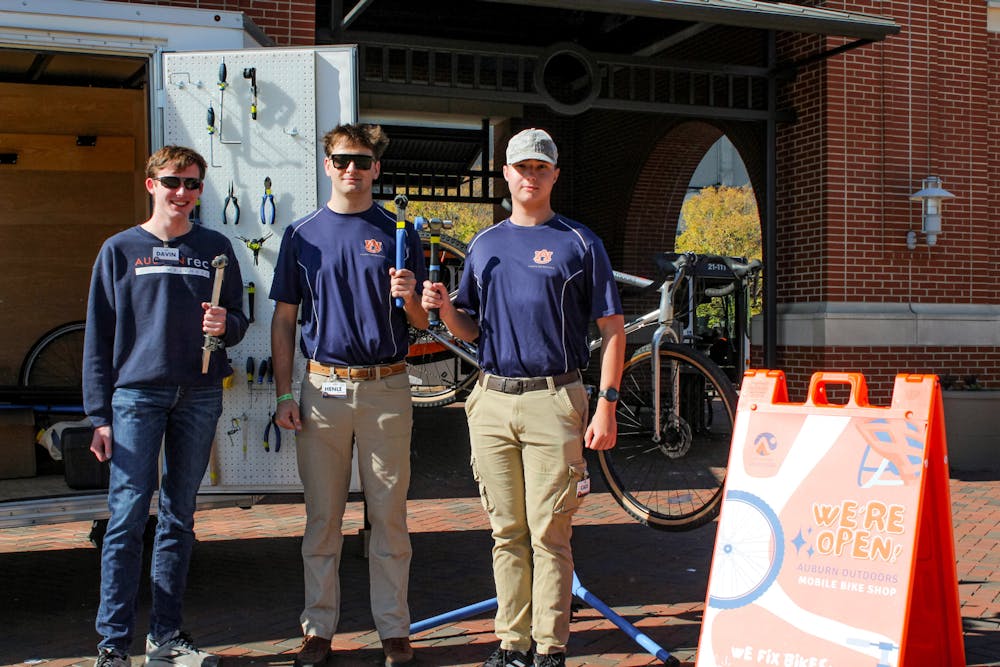Davin Miles and other members of Campus Recreation ready to help people with their bikes at mobile bike shop at Campus Green on Nov. 3, 2023.