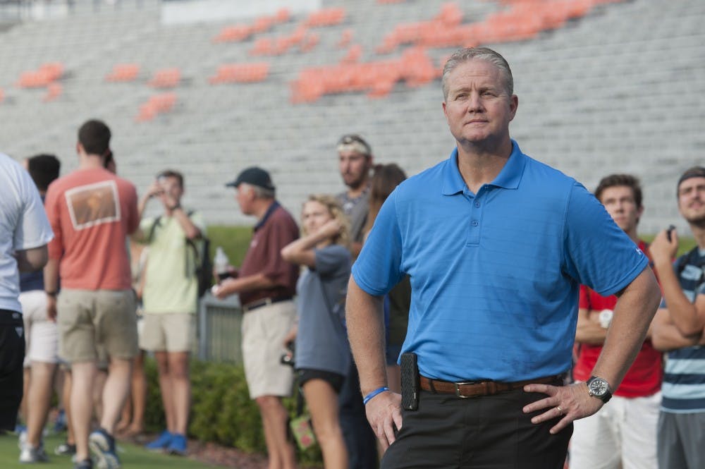 <p>Auburn Athletic Director Jay Jacobs watches the North Carolina vs South Carolina game on the new video board at Jordan-Hare Stadium on Thursday, Sept. 3, 2015.</p>