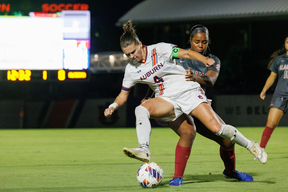 <p>Auburn Women's soccer player Anna Haddock, #4, fights to keep the ball from Alabama's player on Oct. 10, 2024.</p>