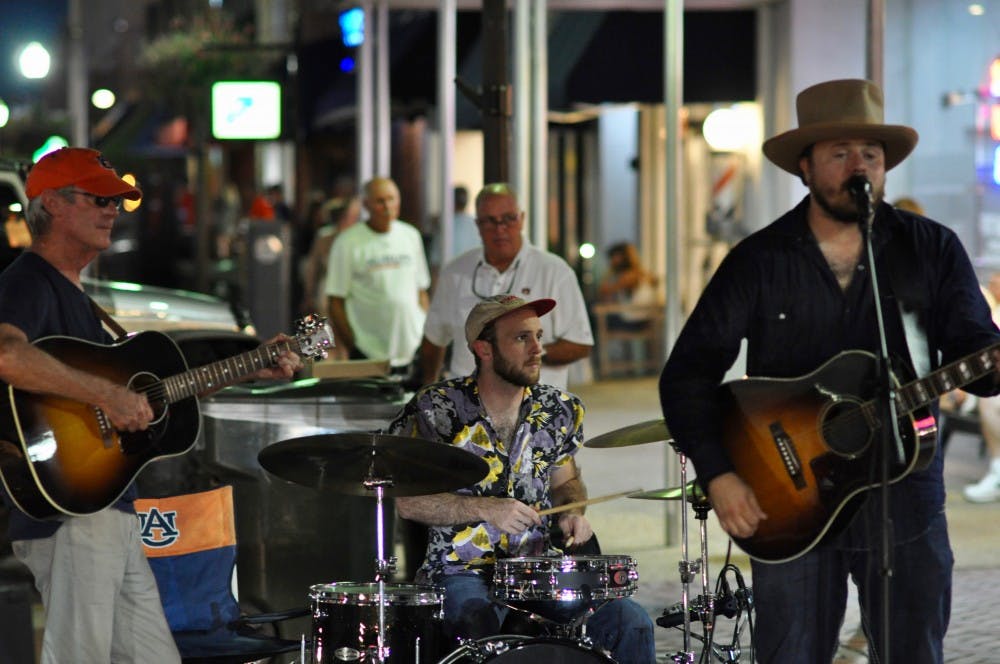 <p>Dallas Dorsey playing at Toomer's Drug's during the Come Home to the Corner event on Friday, Sept. 14, 2018 in Auburn, Ala.</p>